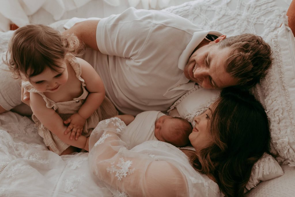 family and newborn photographed together